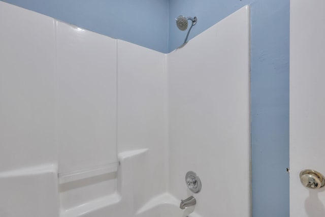 details featuring shower / washtub combination