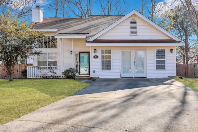 view of front facade with a front yard and french doors