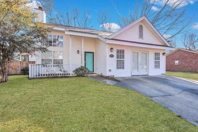 ranch-style home featuring french doors, a porch, and a front yard