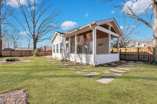 view of side of home with a lawn and a sunroom