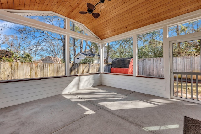 unfurnished sunroom with lofted ceiling, plenty of natural light, wooden ceiling, and ceiling fan