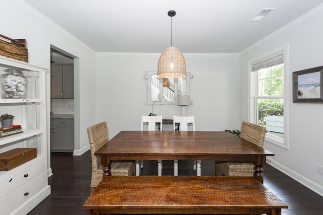 dining area featuring crown molding and dark hardwood / wood-style floors