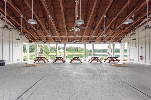 interior space with ceiling fan and a water view