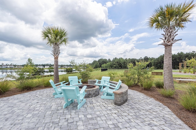 view of patio / terrace with a water view and a fire pit