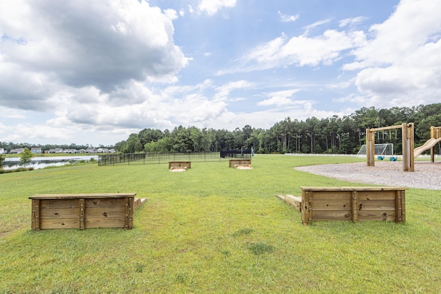 view of yard with a playground and a water view