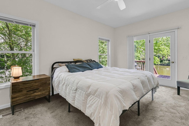 bedroom featuring light colored carpet, access to exterior, and a ceiling fan