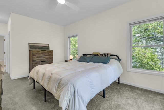 carpeted bedroom with baseboards and a ceiling fan