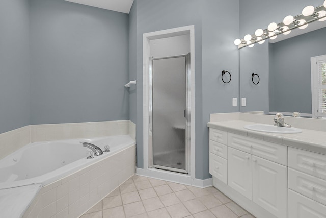 bathroom with a stall shower, a jetted tub, tile patterned flooring, and vanity