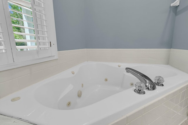 bathroom with a tub with jets