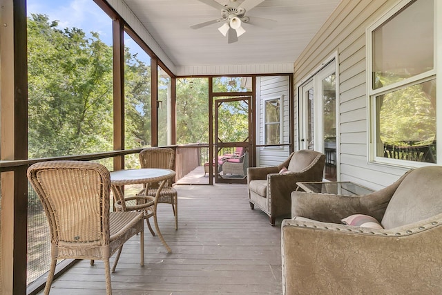 sunroom / solarium featuring ceiling fan