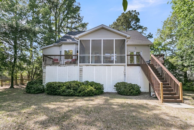 rear view of property with a sunroom, stairway, fence, a deck, and roof with shingles
