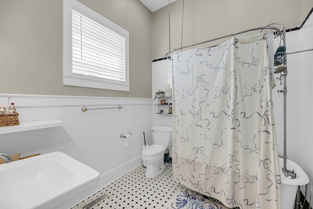 68 Vanderhorst St Unit A, Charleston, SC 29403 - full bathroom featuring a wainscoted wall and tile patterned floors