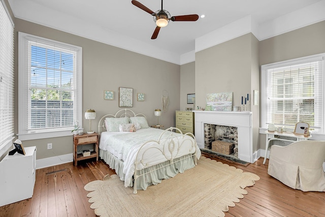 68 Vanderhorst St Unit A, Charleston, SC 29403 - bedroom with hardwood / wood-style flooring, a fireplace, and ceiling fan