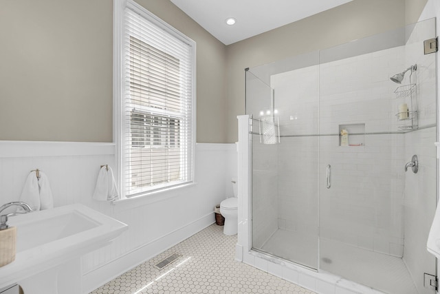68 Vanderhorst St Unit A, Charleston, SC 29403 - full bathroom with a stall shower, a wainscoted wall, and tile patterned floors
