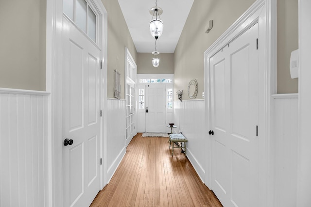 68 Vanderhorst St Unit A, Charleston, SC 29403 - entrance foyer featuring wainscoting, light wood-type flooring, and a decorative wall