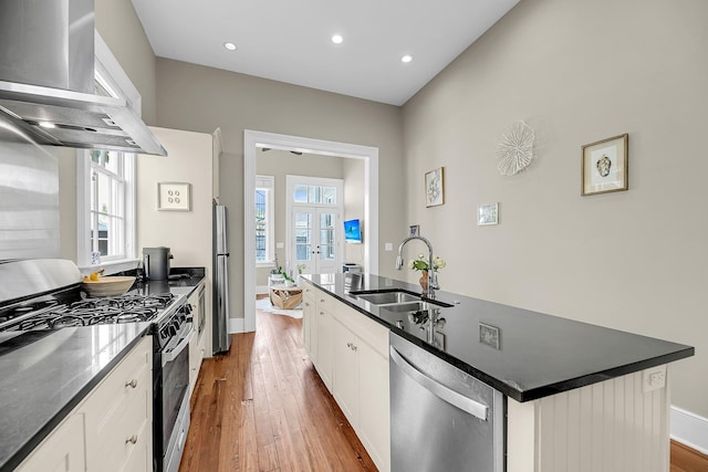 68 Vanderhorst St Unit A, Charleston, SC 29403 - kitchen with appliances with stainless steel finishes, custom exhaust hood, french doors, wood-type flooring, and dark countertops