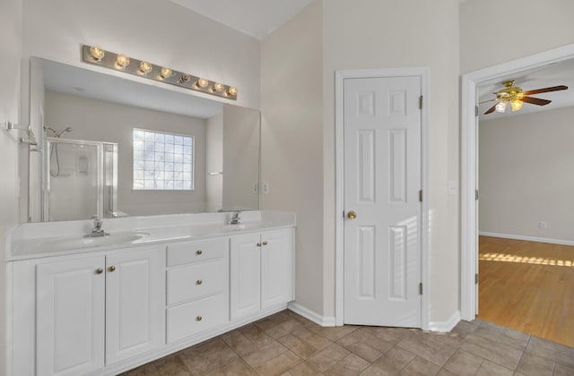 bathroom featuring ceiling fan, vanity, an enclosed shower, and tile patterned flooring