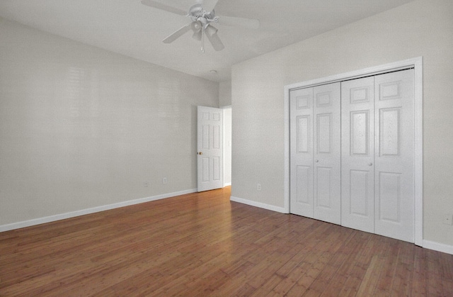 unfurnished bedroom with dark hardwood / wood-style floors, ceiling fan, and a closet