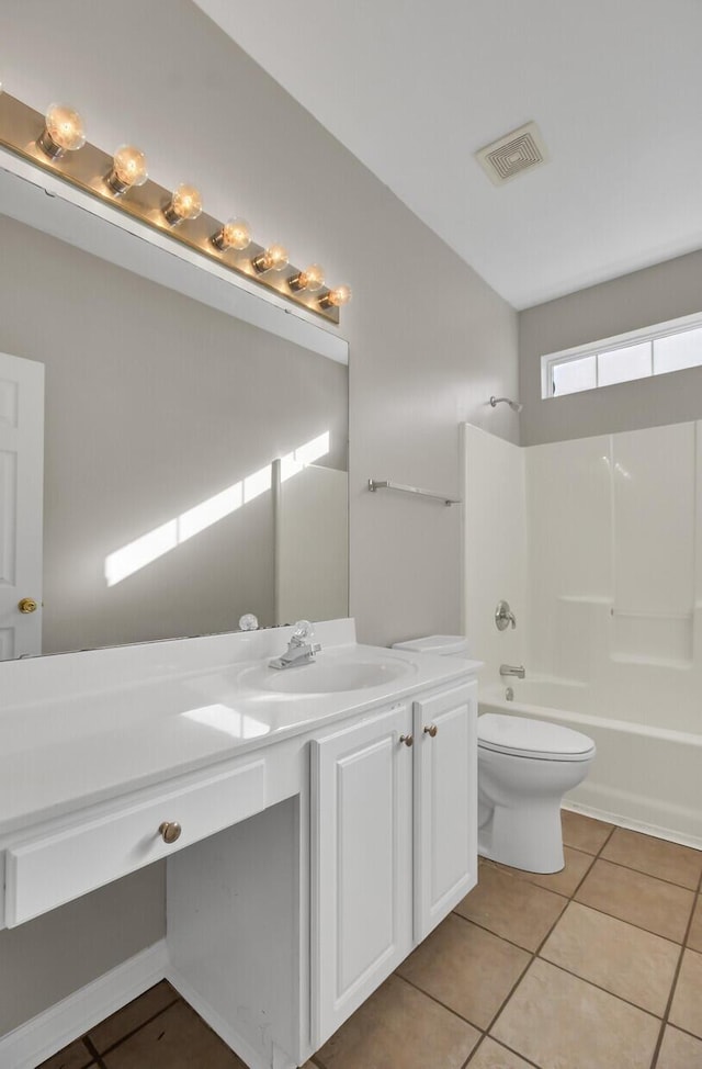 full bathroom with vanity, tub / shower combination, tile patterned floors, and toilet