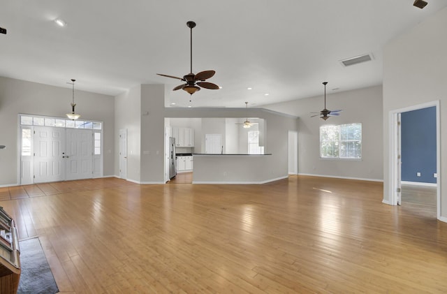 unfurnished living room with ceiling fan and light hardwood / wood-style flooring