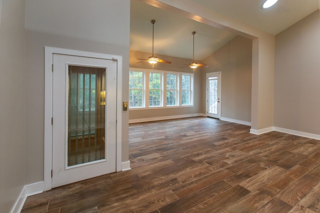 interior space with dark wood finished floors, baseboards, and high vaulted ceiling