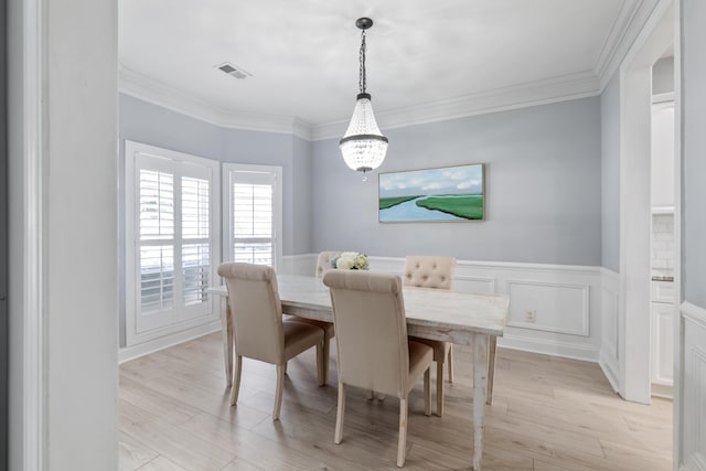 1250 White Tail Path, Charleston, SC 29414 - dining area featuring a chandelier, light wood-style floors, wainscoting, and ornamental molding