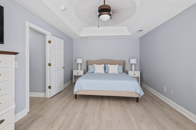 1250 White Tail Path, Charleston, SC 29414 - bedroom featuring light wood-style floors, a raised ceiling, a ceiling fan, and baseboards