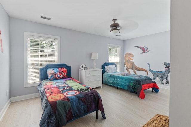 1250 White Tail Path, Charleston, SC 29414 - bedroom featuring multiple windows, wood finished floors, baseboards, and a ceiling fan