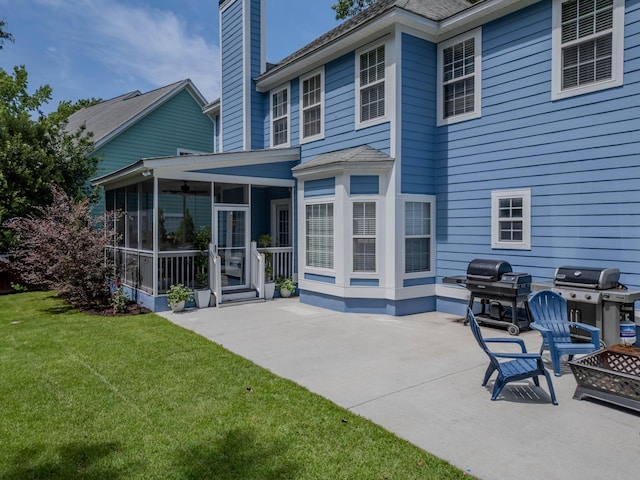 1250 White Tail Path, Charleston, SC 29414 - back of property featuring a sunroom, a patio area, a chimney, a fire pit, and a yard