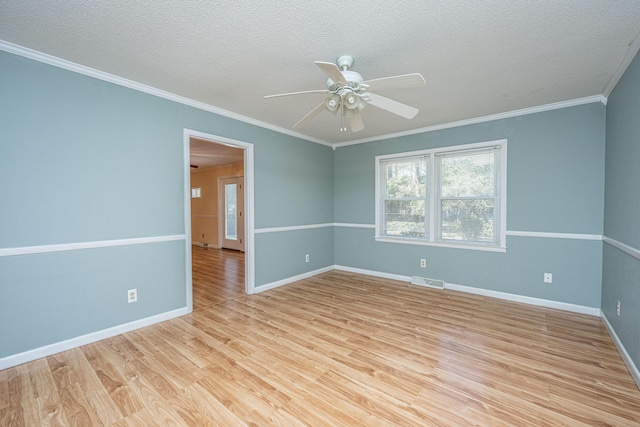 spare room with ceiling fan, ornamental molding, light hardwood / wood-style floors, and a textured ceiling