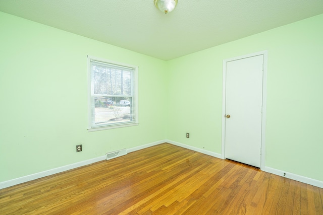 spare room with light hardwood / wood-style flooring