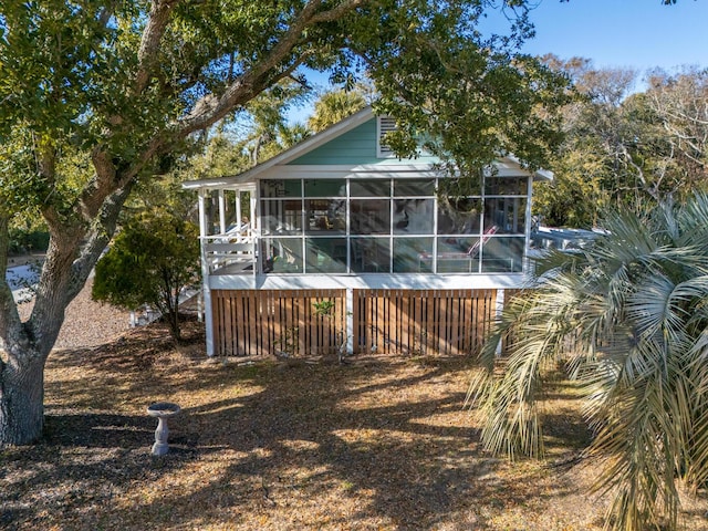 rear view of property with a sunroom