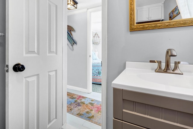 bathroom featuring ornamental molding and vanity