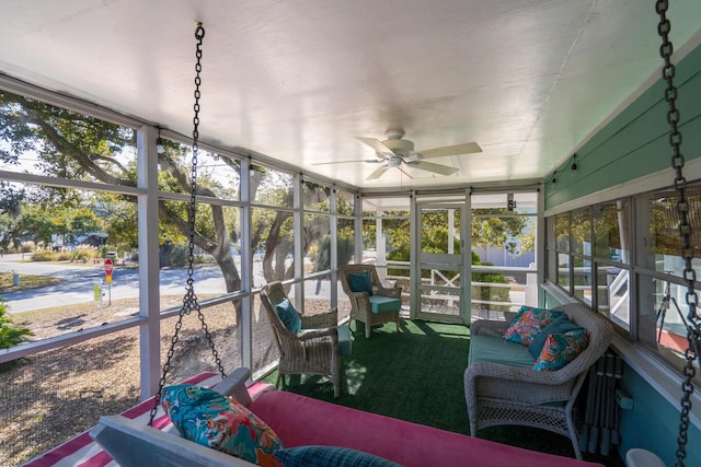 sunroom with a healthy amount of sunlight and ceiling fan