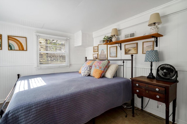 bedroom with tile patterned flooring and crown molding