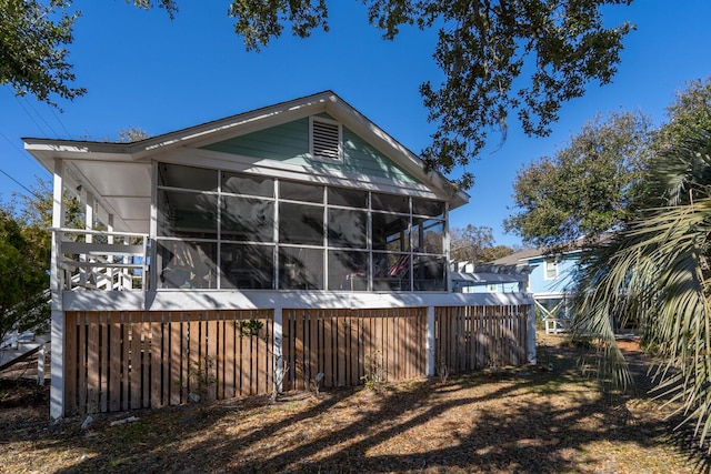 back of house featuring a sunroom