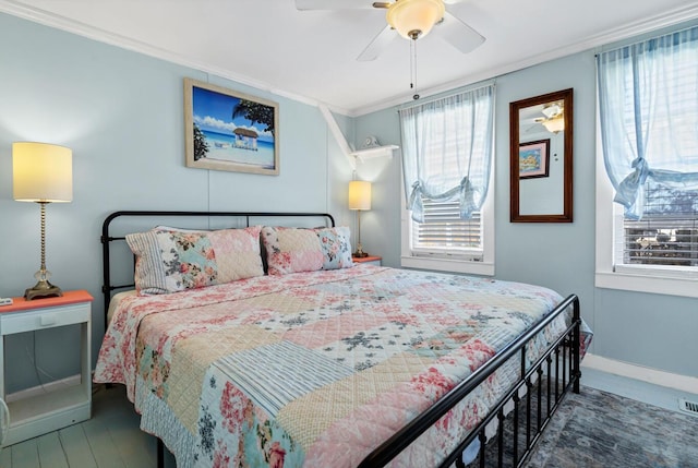 bedroom with crown molding, ceiling fan, and multiple windows