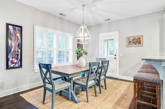 6190 Button Bush Dr, Ravenel, SC 29470 - dining area featuring baseboards, wood finished floors, and a chandelier