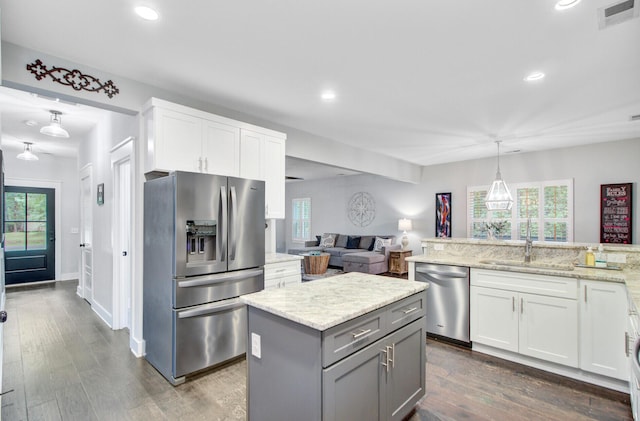 6190 Button Bush Dr, Ravenel, SC 29470 - kitchen with stainless steel appliances, a sink, white cabinets, recessed lighting, and light stone countertops