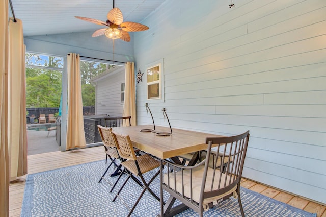 6190 Button Bush Dr, Ravenel, SC 29470 - dining area featuring light wood finished floors, vaulted ceiling, ceiling fan, and wooden walls