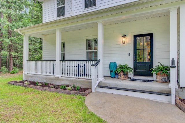 6190 Button Bush Dr, Ravenel, SC 29470 - doorway to property with covered porch and a lawn