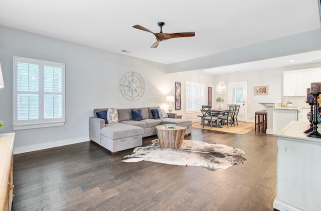 6190 Button Bush Dr, Ravenel, SC 29470 - living area with healthy amount of natural light, dark wood finished floors, ceiling fan, and baseboards