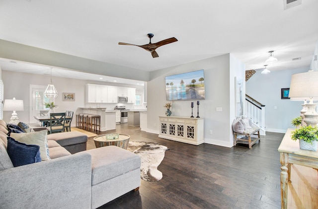 6190 Button Bush Dr, Ravenel, SC 29470 - living area with ceiling fan, wood finished floors, stairs, and baseboards