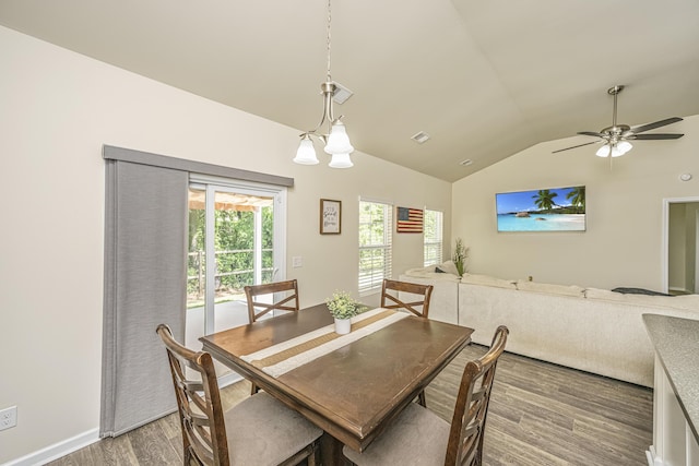 dining space featuring ceiling fan, vaulted ceiling, wood finished floors, and visible vents