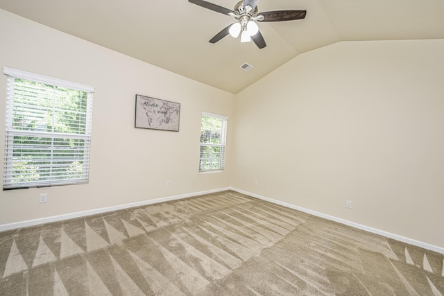 unfurnished room featuring carpet floors, visible vents, baseboards, and lofted ceiling