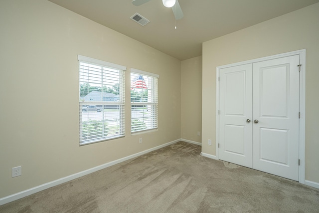 unfurnished bedroom featuring visible vents, a ceiling fan, a closet, baseboards, and carpet flooring