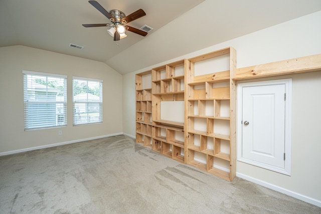 spare room with carpet floors, a ceiling fan, vaulted ceiling, and visible vents