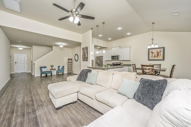 living room with a ceiling fan, visible vents, lofted ceiling, recessed lighting, and dark wood-type flooring