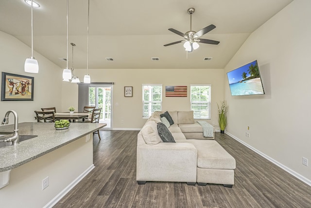 living room featuring dark wood-type flooring, baseboards, a wealth of natural light, and visible vents