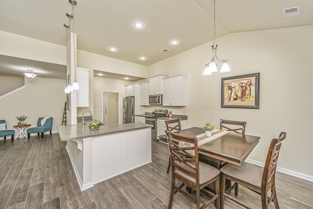 dining room with recessed lighting, baseboards, lofted ceiling, dark wood-type flooring, and visible vents